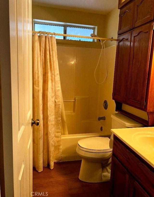 bathroom featuring shower / bath combo, toilet, wood finished floors, and plenty of natural light