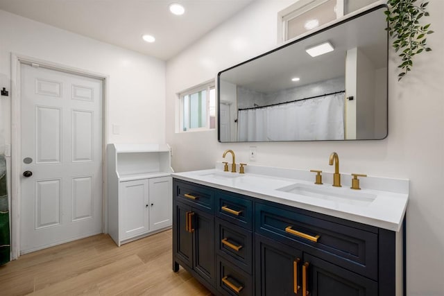 bathroom with curtained shower, vanity, and hardwood / wood-style floors