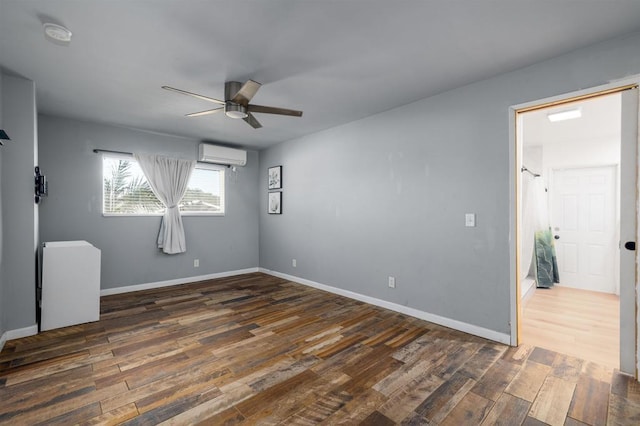 unfurnished room featuring ceiling fan, a wall mounted air conditioner, and dark hardwood / wood-style floors