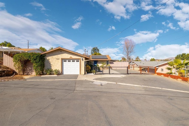 view of front of home with solar panels and a garage