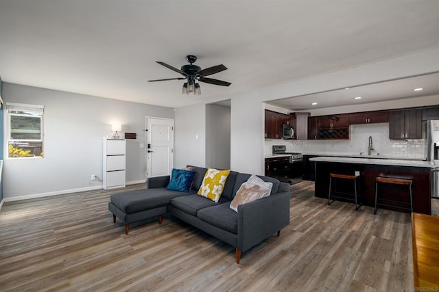 living room with ceiling fan and hardwood / wood-style flooring