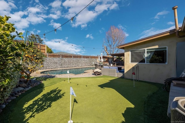 view of yard with a fenced in pool