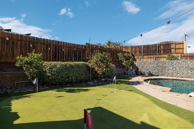 view of yard with a fenced in pool