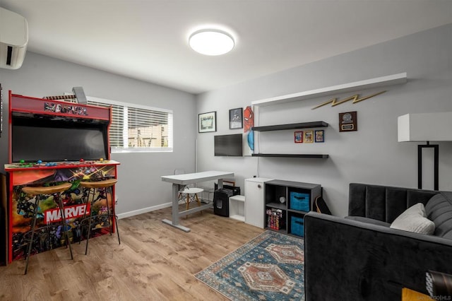 living room featuring an AC wall unit and light hardwood / wood-style flooring