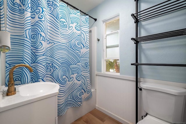 full bathroom featuring sink, toilet, shower / tub combo with curtain, and hardwood / wood-style flooring