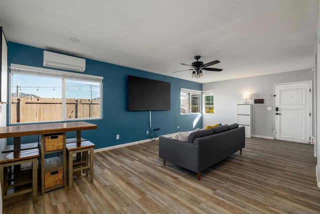 living room featuring ceiling fan, a wall unit AC, and hardwood / wood-style flooring