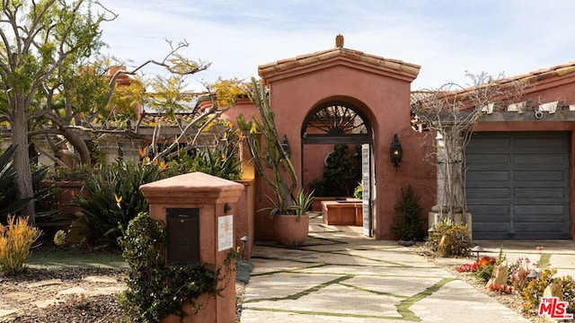 doorway to property with a garage