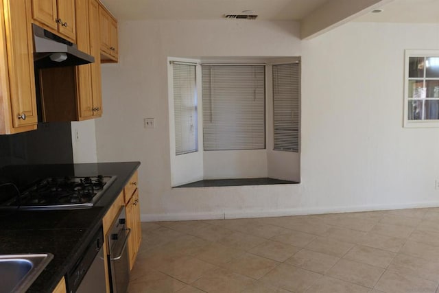 kitchen featuring gas cooktop, dishwasher, light tile patterned floors, and sink