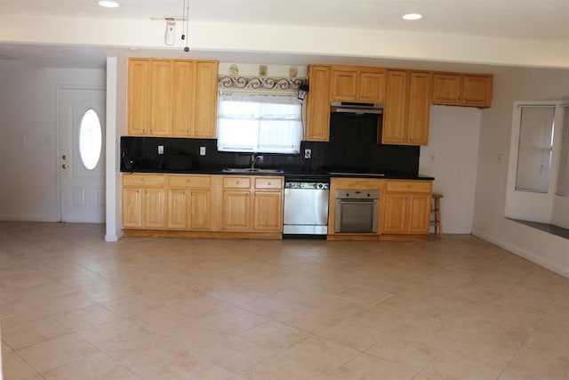 kitchen featuring stainless steel appliances, sink, and backsplash