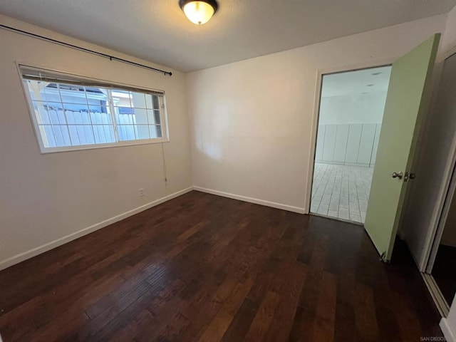 empty room featuring dark wood-type flooring