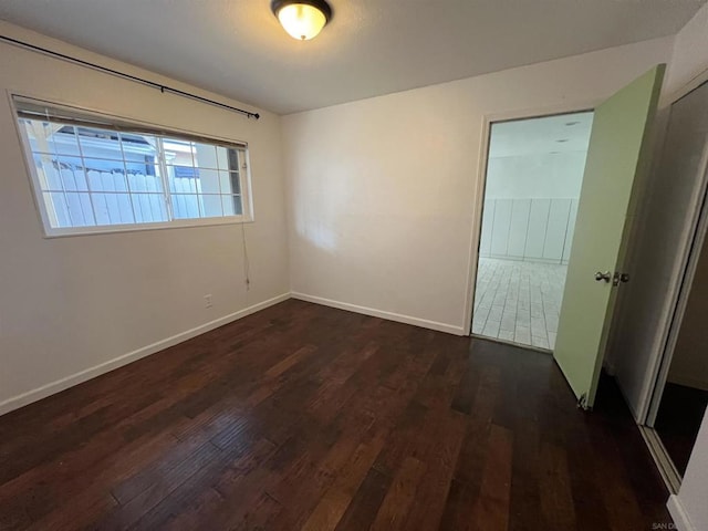 empty room with dark hardwood / wood-style floors