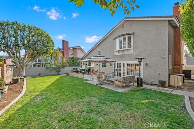 rear view of property featuring central AC unit, a patio area, outdoor lounge area, and a yard