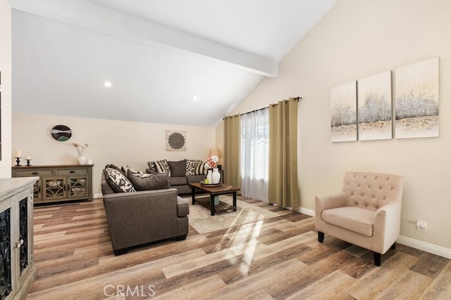 living room featuring hardwood / wood-style flooring and lofted ceiling with beams