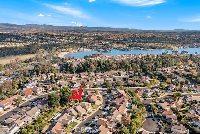 birds eye view of property with a water and mountain view