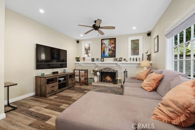 living room featuring ceiling fan and hardwood / wood-style floors