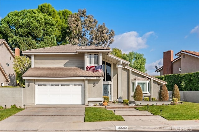 view of front of home featuring a garage and a front lawn