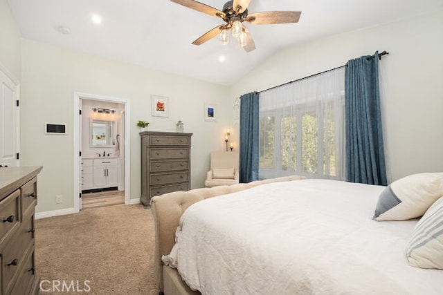 bedroom with vaulted ceiling, ceiling fan, ensuite bathroom, and light carpet