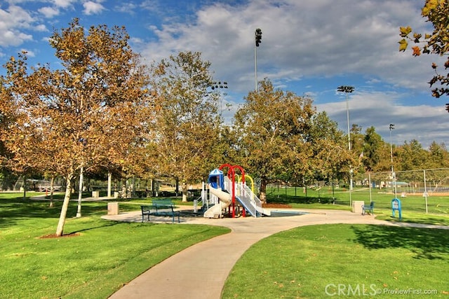 surrounding community with a playground and a yard