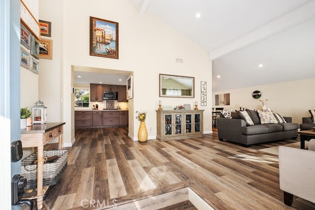 living room with high vaulted ceiling, wood-type flooring, and beamed ceiling