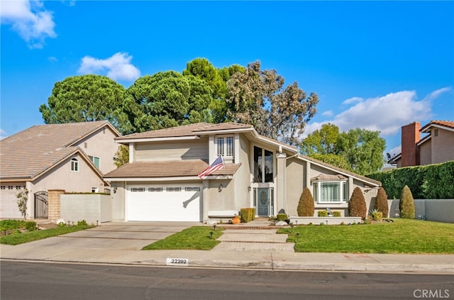 view of front property featuring a front yard and a garage