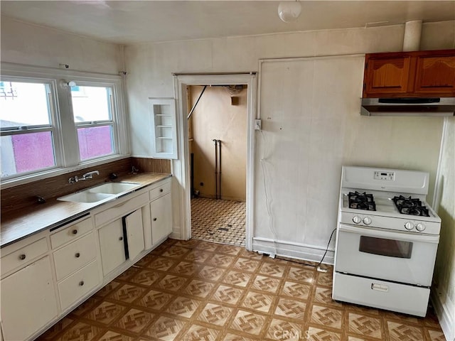 kitchen featuring sink and white gas range oven