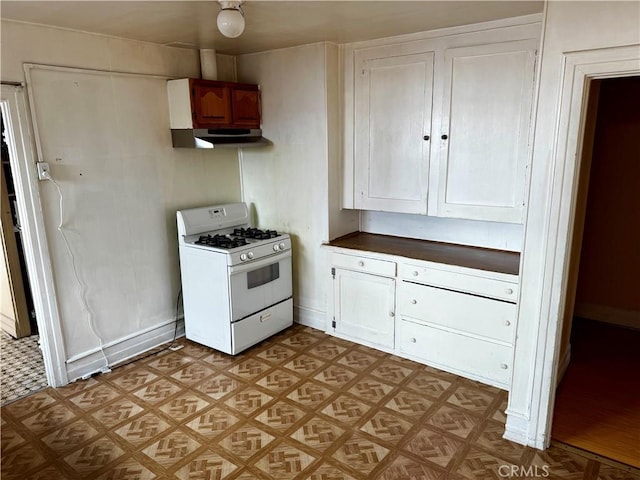 kitchen featuring light parquet flooring, white cabinetry, and gas range gas stove