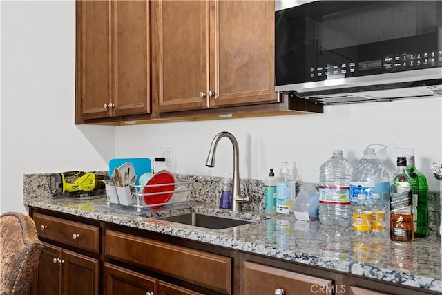 kitchen with sink and light stone countertops