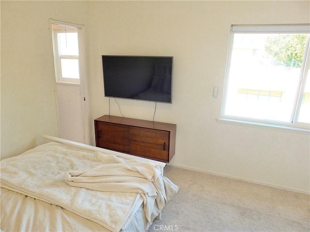 carpeted bedroom featuring baseboards