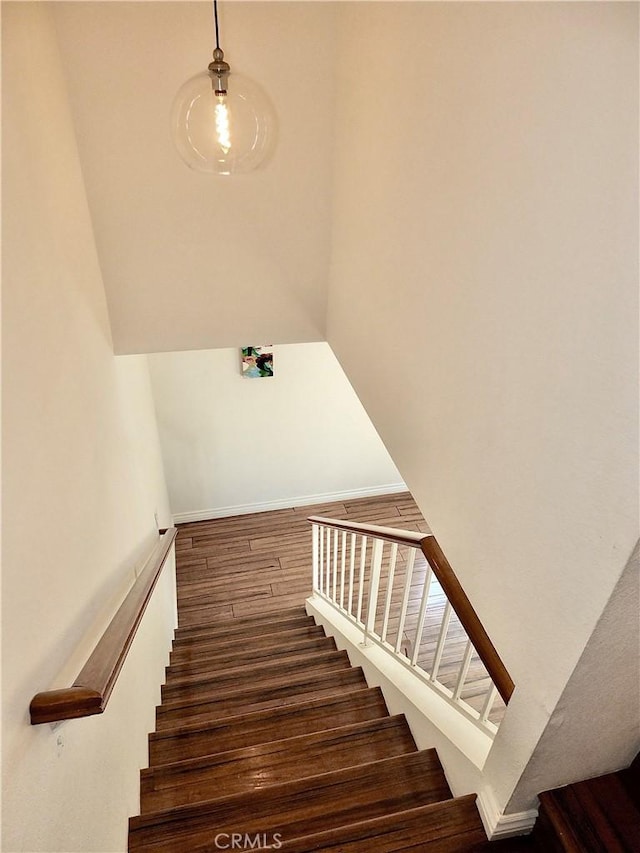 stairs featuring wood finished floors