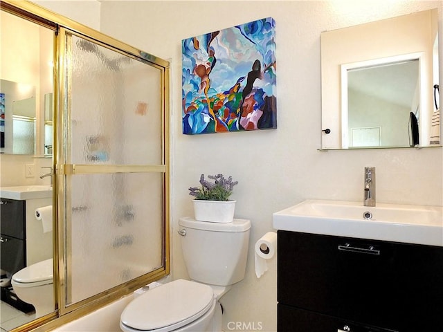 full bathroom with vanity, toilet, and enclosed tub / shower combo