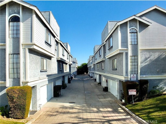 view of road featuring a residential view and driveway