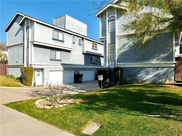 view of home's exterior with concrete driveway, an attached garage, and a lawn