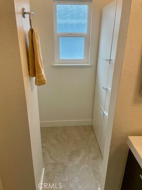 bathroom featuring vanity and baseboards