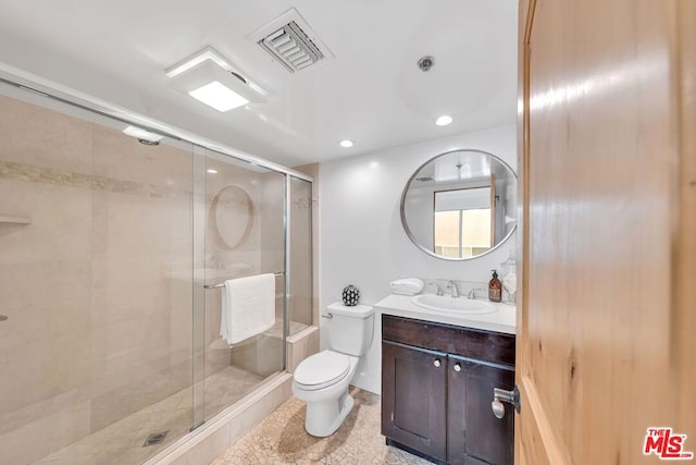 bathroom with toilet, an enclosed shower, and vanity