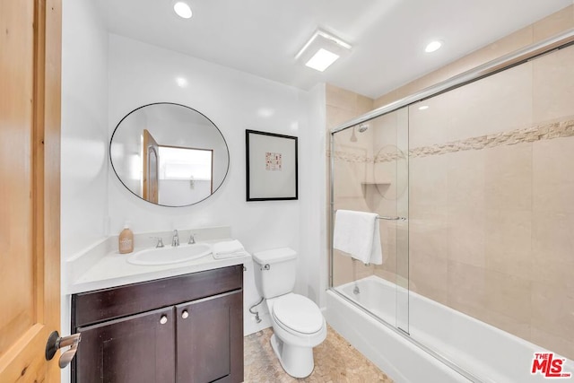 full bathroom featuring toilet, vanity, and combined bath / shower with glass door