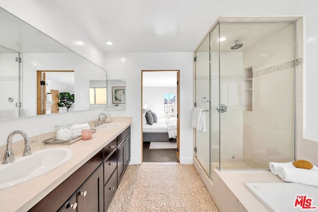 bathroom with tile patterned flooring, an enclosed shower, and vanity