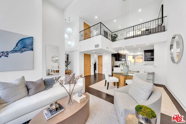 living room with a high ceiling and hardwood / wood-style floors