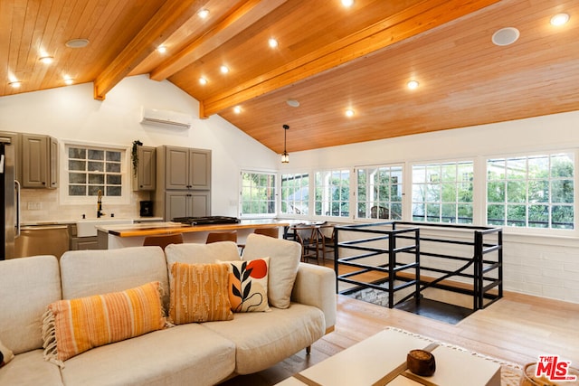 living room with sink, beamed ceiling, light wood-type flooring, a wall unit AC, and high vaulted ceiling