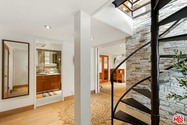 stairs with sink and hardwood / wood-style floors