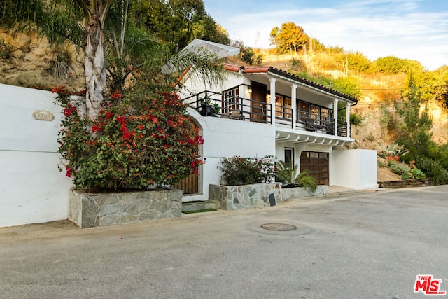 view of front facade with a balcony and a garage