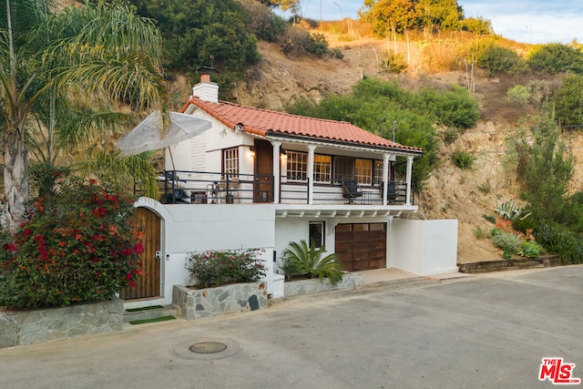 mediterranean / spanish house featuring a balcony and a garage