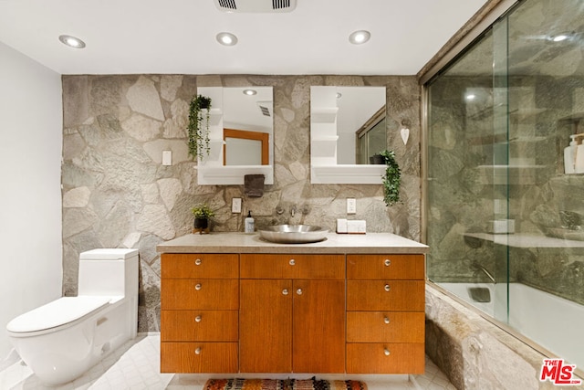 full bathroom with decorative backsplash, bath / shower combo with glass door, vanity, and toilet