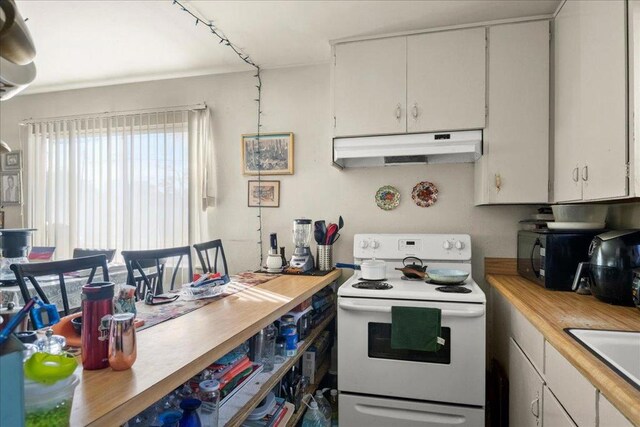 kitchen featuring white cabinetry, sink, wood counters, and white electric range oven