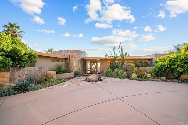 adobe home featuring a patio area