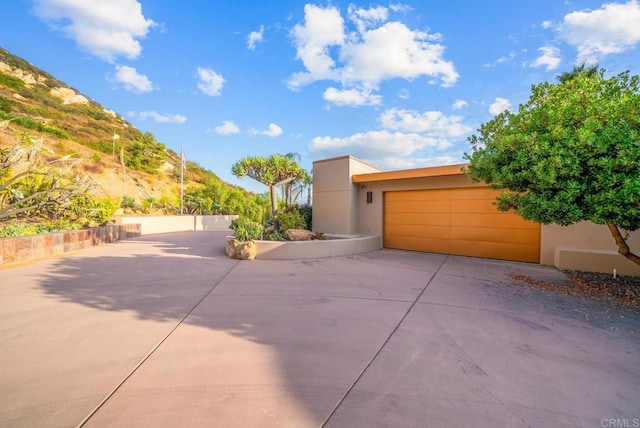 view of front facade featuring a garage and a mountain view