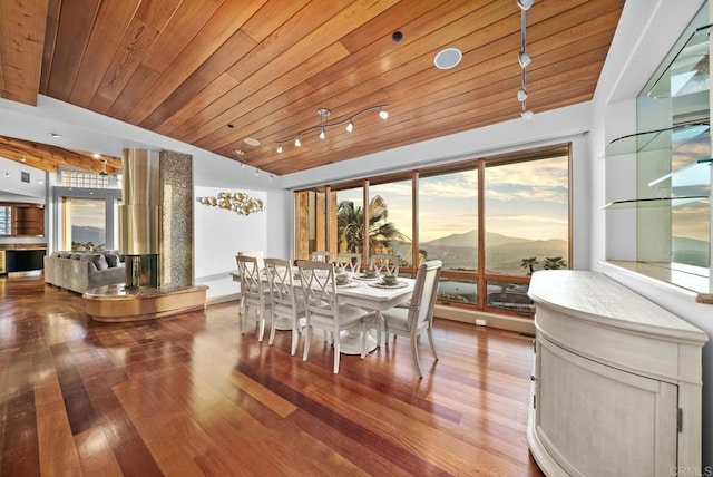 dining space with wood-type flooring, vaulted ceiling, and wood ceiling