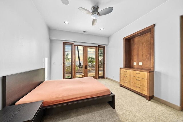 carpeted bedroom with ceiling fan, french doors, and access to exterior