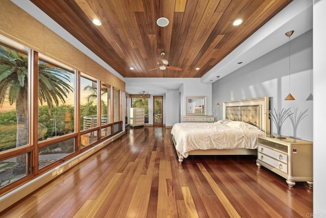 bedroom featuring wooden ceiling, multiple windows, and hardwood / wood-style flooring