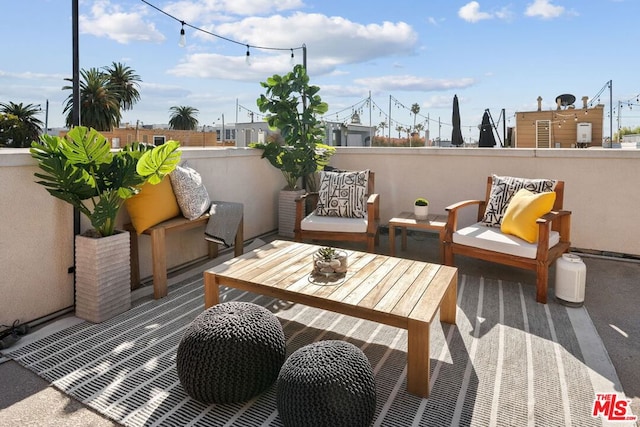 view of patio featuring a balcony and an outdoor hangout area