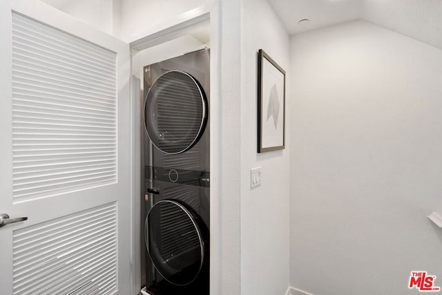 laundry room with stacked washing maching and dryer